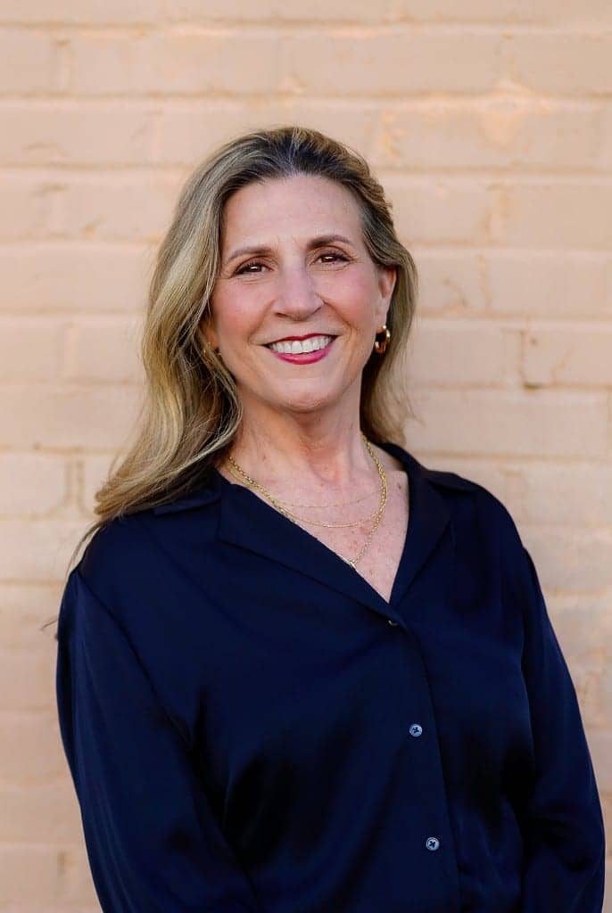 Michelle Dixon, Licensed Professional Counselor, in front of a light brick wall